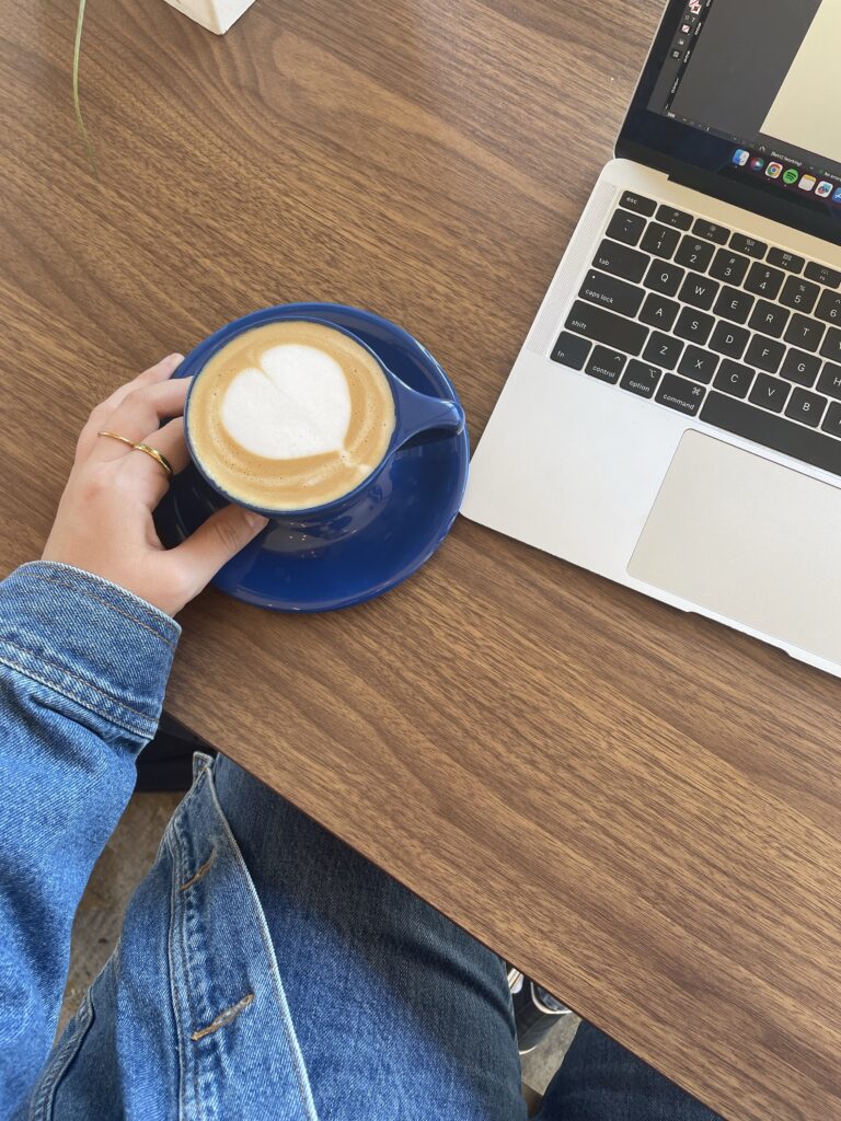 a person holding a cup of coffee
