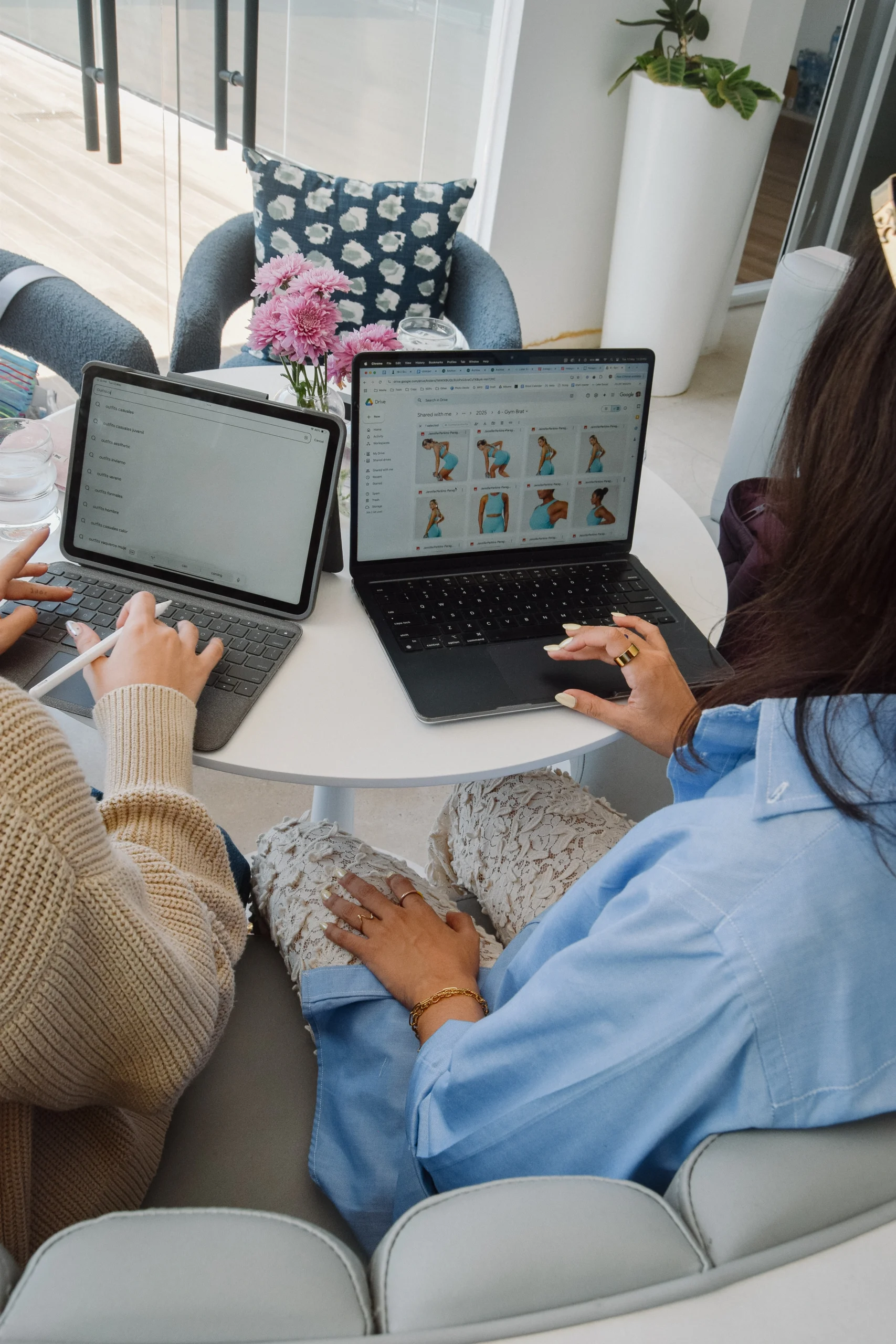 a group of women sitting at a table with laptops